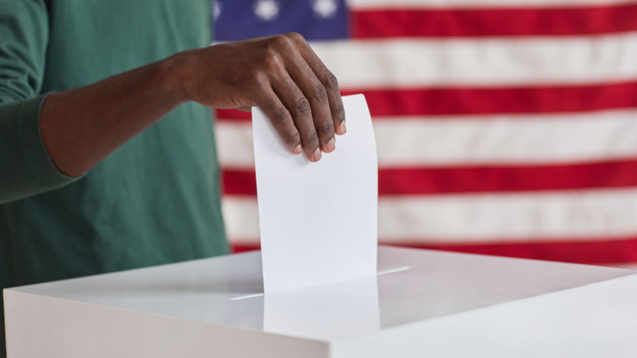 close-up-african-man-putting-ballot-n-box-federal-election